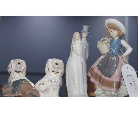 GROUP OF LLADRO AND NAO FIGURINES
including a Lladro figurine of a young girl bearing a basket of flowers, Lladro figure mode