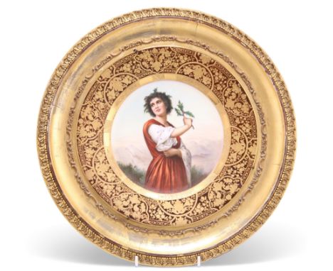 A 19TH CENTURY VIENNA PORTRAIT PLAQUE, titled "Distel" verso, circular, signed, the broad rim richly gilded, underglaze blue 