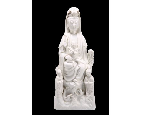 A LARGE CHINESE BLANC DE CHINE MODEL OF A GUANYIN, PROBABLY KANGXI PERIOD,&nbsp;modelled with attendants. 35cm high