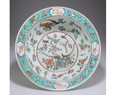 A CHINESE FAMILLE ROSE PORCELAIN BASIN, 19TH CENTURY, circular, enamel painted with peacocks and other birds amidst rockwork 