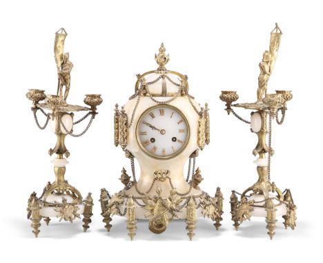 A FRENCH GILT-METAL MOUNTED ONYX CLOCK GARNITURE, 19TH CENTURY,&nbsp;the clock clad with trophies and with Roman numerals, tw