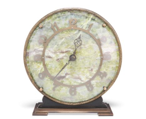 AN ART DECO SMITHS EIGHT-DAY ONYX MANTLE CLOCK, the circular onyx dial with brass Arabic numerals, to a stepped brass base. 1