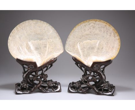 A PAIR OF CHINESE CARVED MOTHER-OF-PEARL SHELLS, MID-19TH&nbsp;CENTURY, finely relief decorated with pagodas, fish and warrio