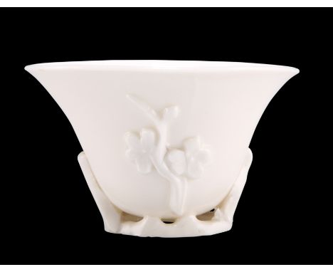 A CHINESE BLANC DE CHINE LIBATION CUP, PROBABLY KANGXI PERIOD, moulded with prunus. 8.5cm wideCONDITION REPORTNo chips, crack