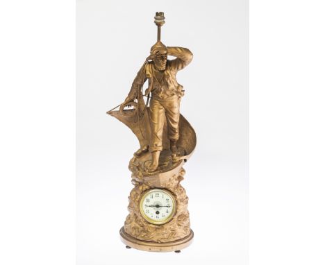 A 19TH CENTURY FRENCH SPELTER CLOCK LAMP, the circular dial within a naturalistic sea-form case surmounted by the figure of a