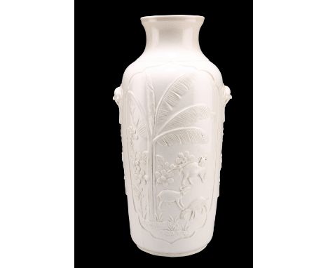 A BLANC DE CHINE VASE, of shouldered ovoid form, moulded with goats and cranes to shaped recessed reserves, drilled as a lamp