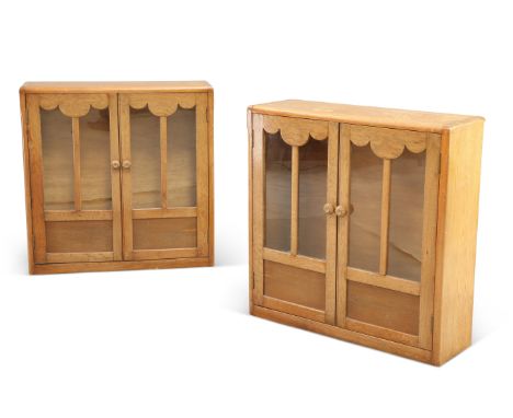 A PAIR OF ART DECO OAK BOOKCASES, each with a pair of glazed and panelled doors, enclosing glass shelves. (2) 82cm high, 82cm