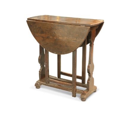 A LATE 17TH CENTURY OAK GATELEG TABLE, OF SMALL PROPORTIONS, the oval dropleaf top raised on silhouette trestle ends with pla