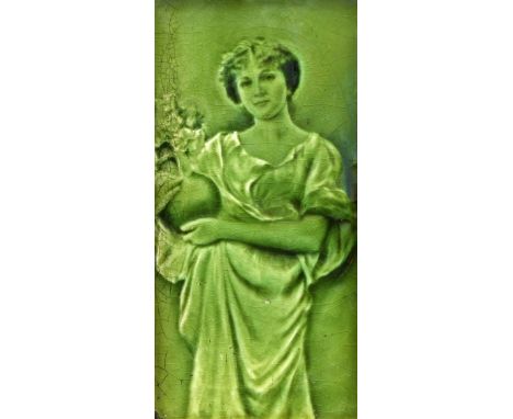 A GREEN-GLAZED MAJOLICA PICTURE TILE, CIRCA 1900, depicting a lady holding a vase of flowers, in a gilt frame. 47.5cm by 31.5