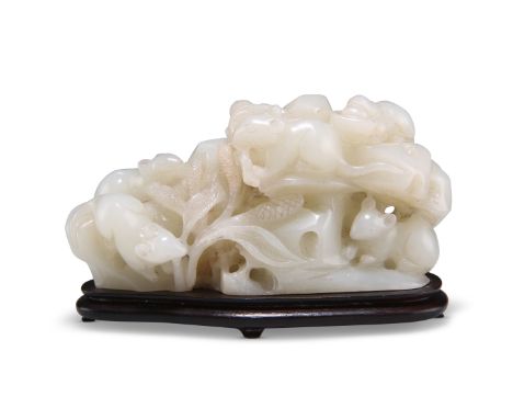 A CHINESE JADE CARVING OF MICE, the five mice depicted eating plants amongst rockwork, on a hardwood base, the jade of pale c