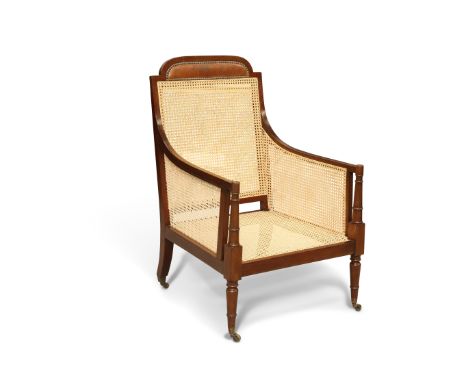 AN EDWARDIAN MAHOGANY AND CANEWORK BERGÈRE, IN GEORGE III STYLE, the crest rail with brown leather headrest, the arms with ri