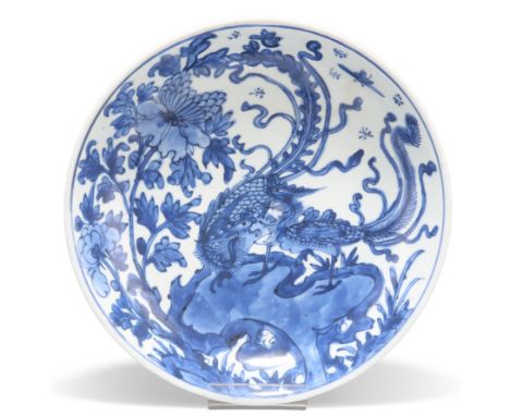 A CHINESE PORCELAIN BLUE AND WHITE CIRCULAR SAUCER DISH, 17TH CENTURY, painted to the centre with two phoenix birds perched o