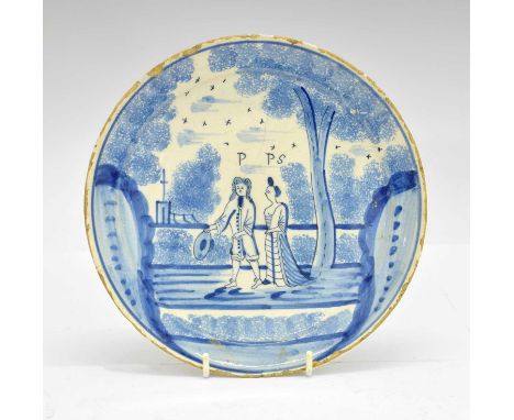 Late 17th century Dutch Delft dish, decorated in blue with portrait of a couple in a garden, initialled above 'P' &amp; 'PS',