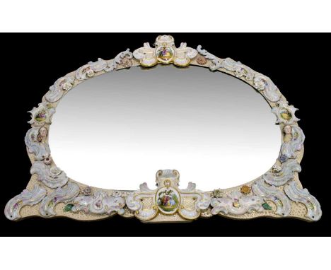 Continental porcelain mounted and encrusted wall mirror, circa 1900, the oval plate enclosed within shaped frame mounted with