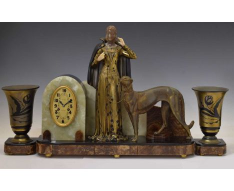 French Art Deco onyx, slate and gilt spelter three piece clock garniture, of imposing scale, the oval gilt Arabic dial with r