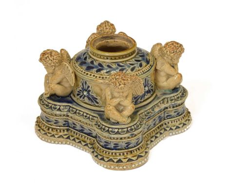 Doulton Lambeth stoneware inkwell, after a design by George Tinworth, of stepped form with cylindrical neck flanked by four w