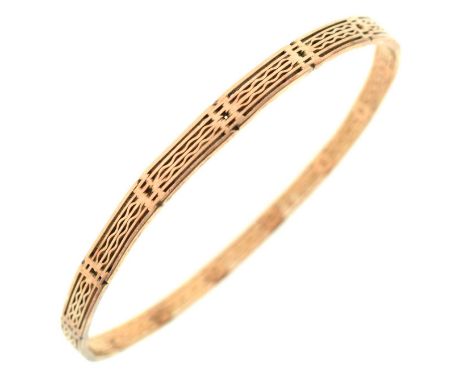 9ct gold bangle of pierced panel design, marked 'JS&amp;S 9ct', 7.9cm diameter, 18.8g approx