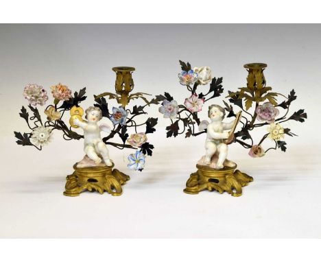 Pair of late 19th century Continenal gilt metal and porcelain mounted figural candlesticks, each modelled in 18th century Mei