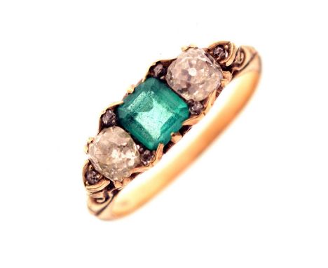 Emerald and diamond three stone yellow metal ring, the square step cut emerald measuring approx. 4.86mm x 4.77mm x 2.49mm, ca