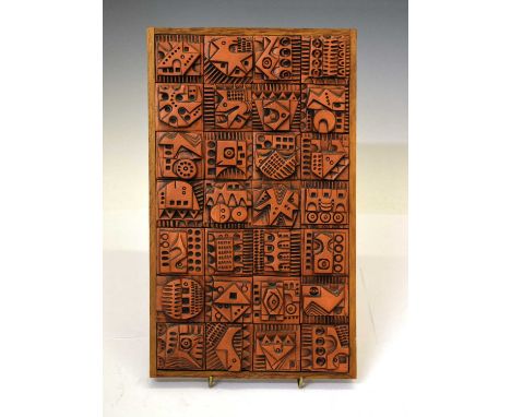 Ron Hitchins (1926-2019) - Ceramic Modernist panel, composed of twenty-eight square tiles moulded in relief with geometric de