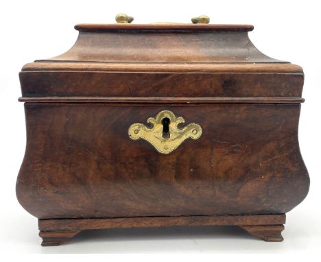 A George II walnut tea caddy, circa 1740,  of sarcophagus form, opening to three compartments, one retaining a tin and brass 