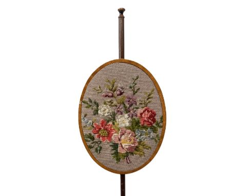 A small George III style mahogany pole screen,   with floral gros point floral panel on tripod base, 133 cm high.