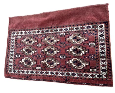 A Turkmen Yomut Chuval rug, early 20th century, with nine guls on a light red field, 105cm x 74cm  The Alastair & Sheila Broo