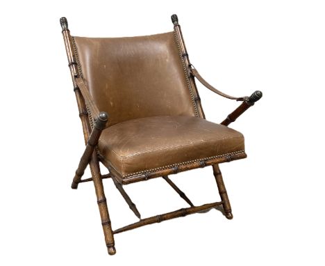 A Campaign style Officer's chair, 20th century, in manner of Maison Jansen,   with faux bamboo turned x-framed supports, and 