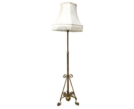 A Victorian gilt brass adjustable oil lamp stand, converted,   with triform scroll footed base, 187 cm high, with shade.  The
