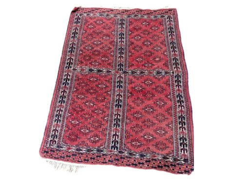 An unusual Tekke Turkman Ensi rug, early 20th century,   the light crimson field divided into quarters, each with multiple gu