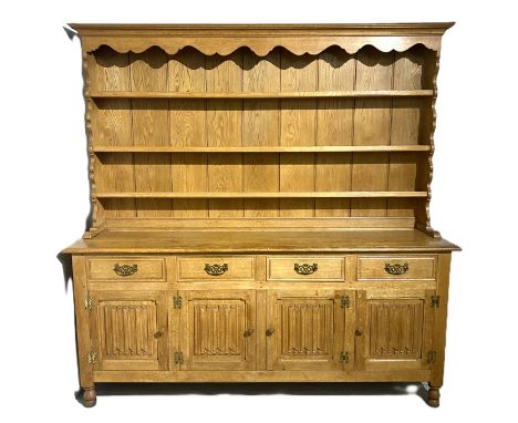 A Welsh style oak dresser, 20th/21st century, with Frank Watt of Derby label,  with boarded three shelf plate rack over a bas
