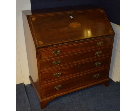 A George III mahogany inlaid writing bureau, with pull down drop flap enclosing fitted drawers and pigeon holes, above four g