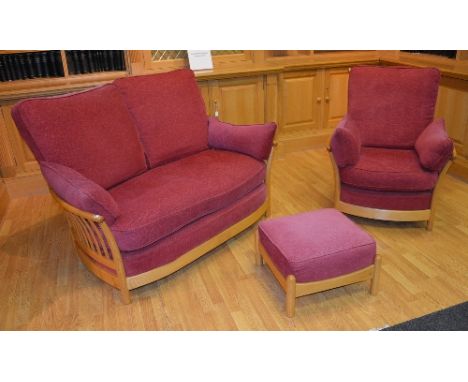 A blonde Ercol three piece lounge suite, light ash colour to the frame, comprising of the two seater settee, armchair and foo