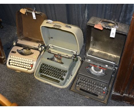 Three vintage typewriters by Olivetti, Scheidegger and Olympia, all in fitted cases (3)