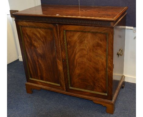 A George III style mahogany chest of drawers circa 19th century, with two panelled doors operating on a metal rod, enclosing 