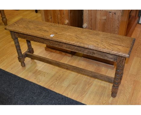 An oak stool, with rectangular top, raised on bobbin type supports, 46cm high x 107cm wide x 26cm deep