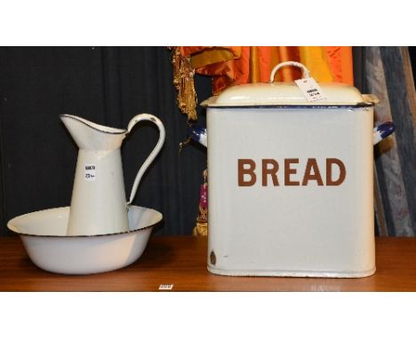 A vintage enamel bread bin with cover, 33cm high, also with an enamel toilet jug and bowl (3)