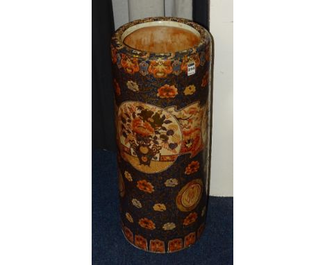 A late 19th/early 20th century Japanese Imari stick stand, decorated with floral panels of reds, blue and golds, 62cm high (a