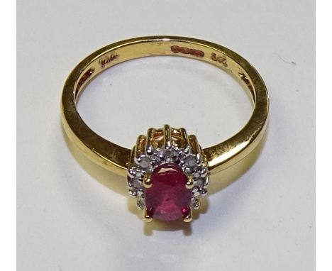 A silver gilt ruby and diamond ring, the central oval cut ruby mounted by 16 milidiamonds, stamped 925 DIA to underside, ring