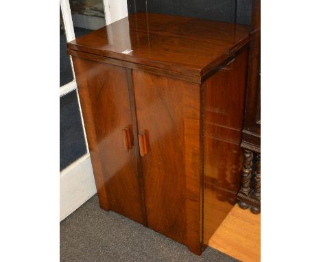 A vintage Singer sewing machine, in walnut two door cupboard