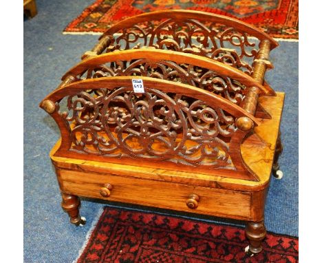 A Victorian walnut Canterbury, with three fretwork divisions to the top above single drawer, raised on turned supports with c