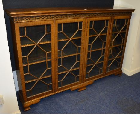 A mahogany four door bookcase, with four glazed astragal doors, enclosing shelved interior, raised on bracket supports, 122cm