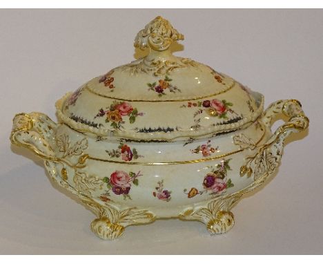 An old English pottery soup tureen and cover, the allover floral panels on white ground with acorn relief decoration and flow