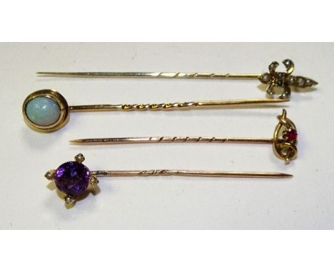 Four gold tie pins, two stamped 9ct, one rubbed and one stamped 14ct, all of varying design including amethyst, opal, ruby an