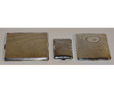 Three silver cigarette cases, of various sizes, one with hallmarks for Birmingham 1938 T & S, with engine turned decoration a