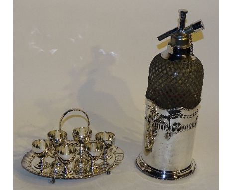 A vintage soda syphon, in plated bottle stand, 37cm high, together with a six setting plated egg epergne (2)