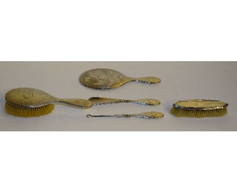 A silver backed brush set, comprising hair brush, clothes brush and mirror, with matching shoe horn and button hook, hallmark