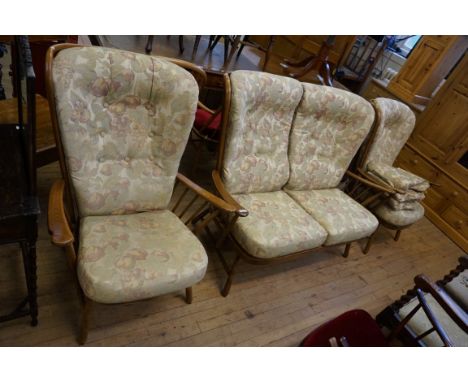 An Ercol light elm three piece settee suite, with upholstered seat, back and arms.