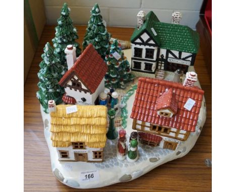 An illuminated ceramic Christmas plateau, in the form of a Alpine village, approx 46cm wide.
