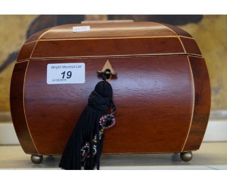 A reproduction Regency style jewellery box in the form of a tea caddy, the hinge lid enclosing a lined and fitted interior co